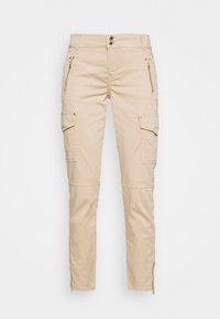 Beige cargo kalhoty se slim fit, s kapsami na zip, zlatými detaily a zipy na kotnících pro nastavitelné otevírání nohavic.