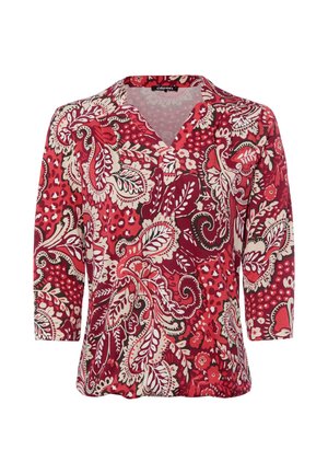 Red blouse with white and dark red floral and paisley patterns, three-quarter sleeves, and a V-neck collar.