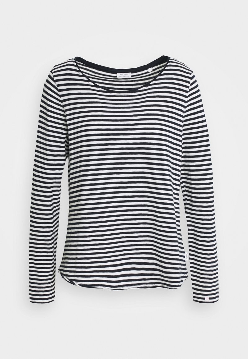 Camisa de manga larga a rayas en blanco y negro, de tejido suave, con escote amplio, dobladillo redondeado y aberturas laterales para mayor facilidad de movimiento.