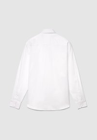 Chemise blanche à manches longues en coton, dotée d'un col classique, de poignets boutonnés et d'une texture lisse avec un détail de griffe dans le dos.