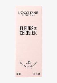 L'Occitane Fleurs de Cerisier eau de toilette förpackning, mjuk rosa texturerad låda med svart text, 50 ml, 1,6 fl oz kapacitet.