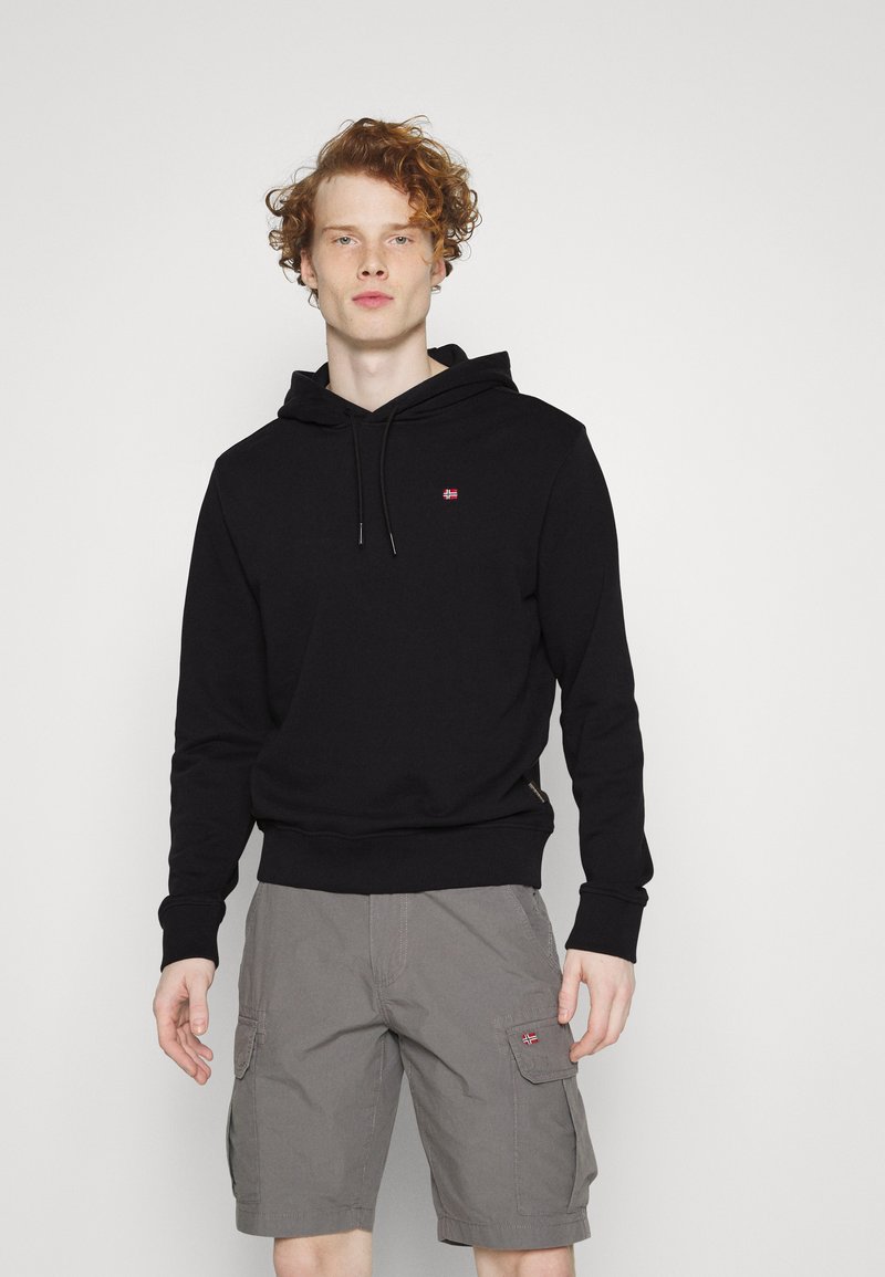 Schwarzer Kapuzenpullover mit Fronttasche und Kordelzug, kombiniert mit grauen Cargo-Shorts mit Seitentaschen und einem kleinen bestickten Detail.