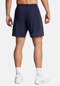 Navy athletic shorts featuring an elastic waistband and smooth fabric, with a knee-length design and subtle side panel accents.
