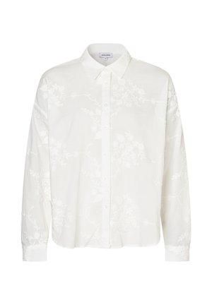 Chemise blanche à manches longues avec un motif floral brodé, col, devant boutonné, en tissu léger. Coupe décontractée avec manches retroussées.