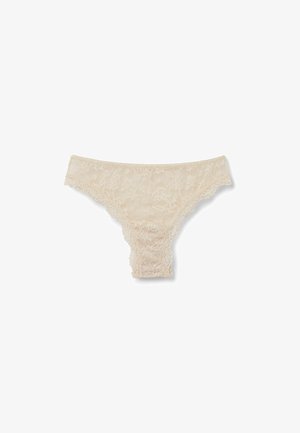Cream lace thong with floral pattern, scalloped edges, and soft texture. Features adjustable sides for comfort and fit.