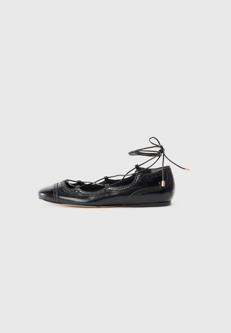 Black patent leather ballet flats with cut-out detailing and a lace-up closure. Features rounded toe and decorative perforated accents.