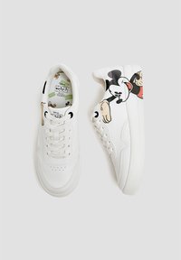 White sneakers featuring a smooth leather upper, lace closure, and graphics of Mickey Mouse on the outer sides. Textured rubber sole.