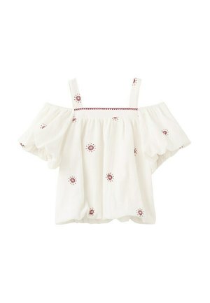 Blouse blanche à bretelles fines, épaules dénudées, manches bouffantes, avec une broderie rouge en forme de soleil dispersée sur le tissu.