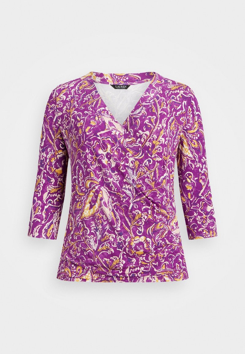 Purple wrap-style top with yellow and white floral pattern and three-quarter sleeves on a plain background.