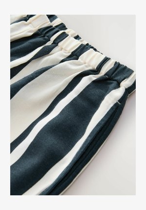 Streepjessstof met verticale donkerblauwe en crèmekleurige lijnen, met een elastische tailleband. Zachte textuur en licht gekreukt uiterlijk.