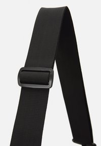 Correia ajustável em nylon preto com textura suave, apresentando uma fivela retangular em plástico preto para ajuste de comprimento.