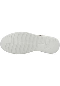 Schuhsohle aus strukturiertem Gummi in Weiß, mit tiefen Rillen für bessere Griffigkeit und einem Prägung des Logos an der Seite. Flache und breite Form.