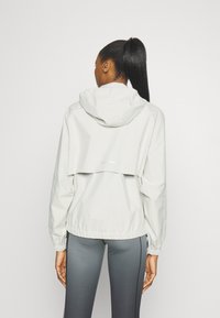 Nike Performance STORM-FIT SWIFT - Running jacket - pale ivory/black/silver