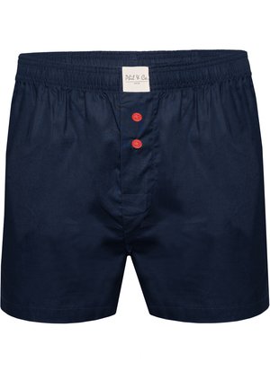 Mørkeblå bomuldsboxershorts med en blød tekstur, elastisk talje, og tre røde knapper foran. Etiketten syet indeni taljen.