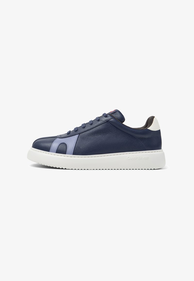Navy blue leather sneaker with light blue side accents, white heel tab, white thick sole, and navy laces, viewed from the side.