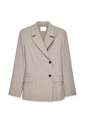Light beige tailored blazer with wide lapels, two black buttons, and flap pockets on front, displayed on white background.