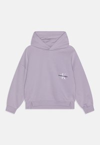 Levandulová mikina s klokaní kapsou a žebrovanými manžetami. Na přední straně se nachází malé logo. Měkká tkanina s uvolněným střihem.