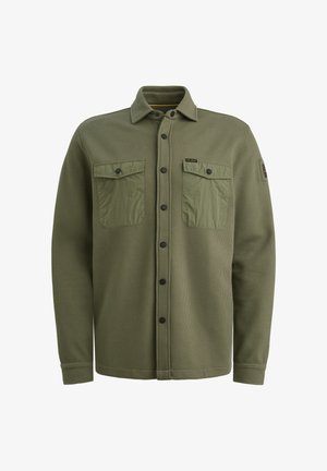 Olivově zelená texturovaná košile-jacket s dvěma předními kapsami, knoflíkovým zapínáním a černými knoflíky. Vyrobena z kombinace materiálů pro teplo.