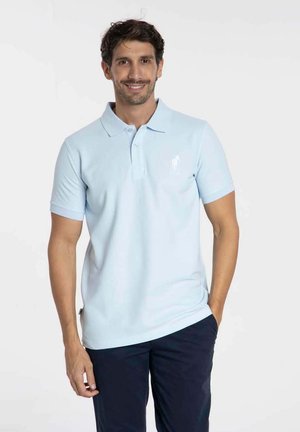 Polo de couleur bleu clair en coton, à manches courtes, avec un col classique et un petit logo sur la poitrine gauche.