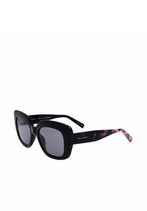 Occhiali da sole quadrati oversize neri con lenti scure e motivo floreale sulle aste interne, firmati Ted Baker sulle aste.