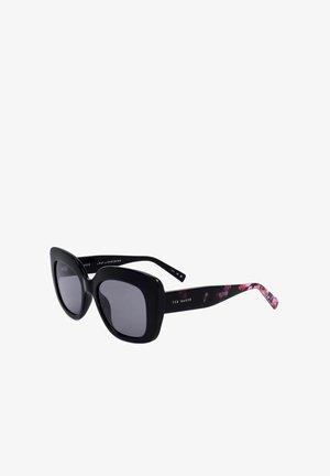 Occhiali da sole quadrati oversize neri con lenti scure e motivo floreale sulle aste interne, firmati Ted Baker sulle aste.