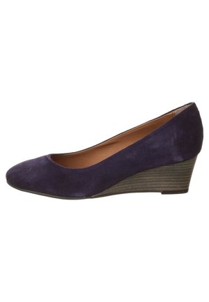 Suede wedge heels in dark navy, featuring a rounded toe and a textured wedge heel. Smooth interior lining, no visible hardware details.