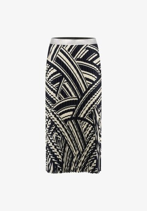 Jupe plissée noir et blanc avec un motif géométrique de feuilles et une taille argentée. Le design comprend des formes et des lignes alternées.