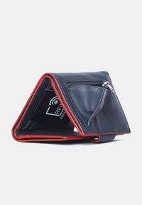 Tri-fold wallet in navy leather with red accents. Features a zippered coin pocket and RFID protection symbol inside. Textured finish.