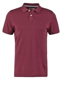 Polo bordeaux en coton, avec un col, une patte de boutonnage à deux boutons et des manches courtes. Texture lisse avec une coupe ajustée.