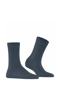 Chaussettes en coton bleu foncé avec un motif en chevrons, dotées de bords côtelés et de pointes renforcées, offrant un design texturé et durable.