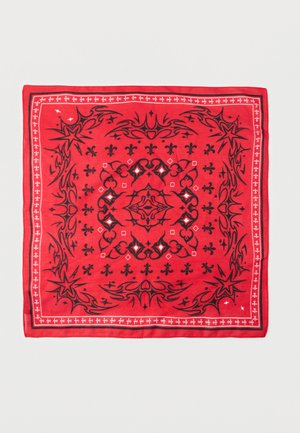 Bandana quadrata rossa con motivi simmetrici di stelle nere, fiamme, cuori e gigli, bordata da linee decorative bianche e nere.