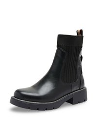 Botte noire en cuir avec tige en tissu côtelé, bout rond, talon épais et détails zippés le long de la semelle. Équipée d'une languette pour un enfilage facile.