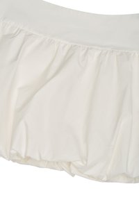 Section de jupe blanche avec détails de tissu froncé et taille lisse, mettant en valeur la texture et la forme.