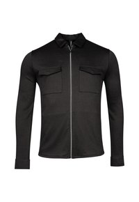 Veste noire zippée en tissu lisse, avec col et deux poches poitrine à rabat. Manches longues avec détails aux poignets.