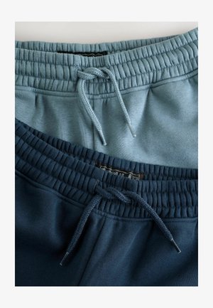 Dve pare trenirk: ena v svetlo modri in ena v temno modri barvi. Obe imata elastične pasove z vrvico in gladko teksturo.