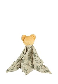 Plush bear head in soft yellow fabric, draped with a light beige blanket featuring green botanical patterns.