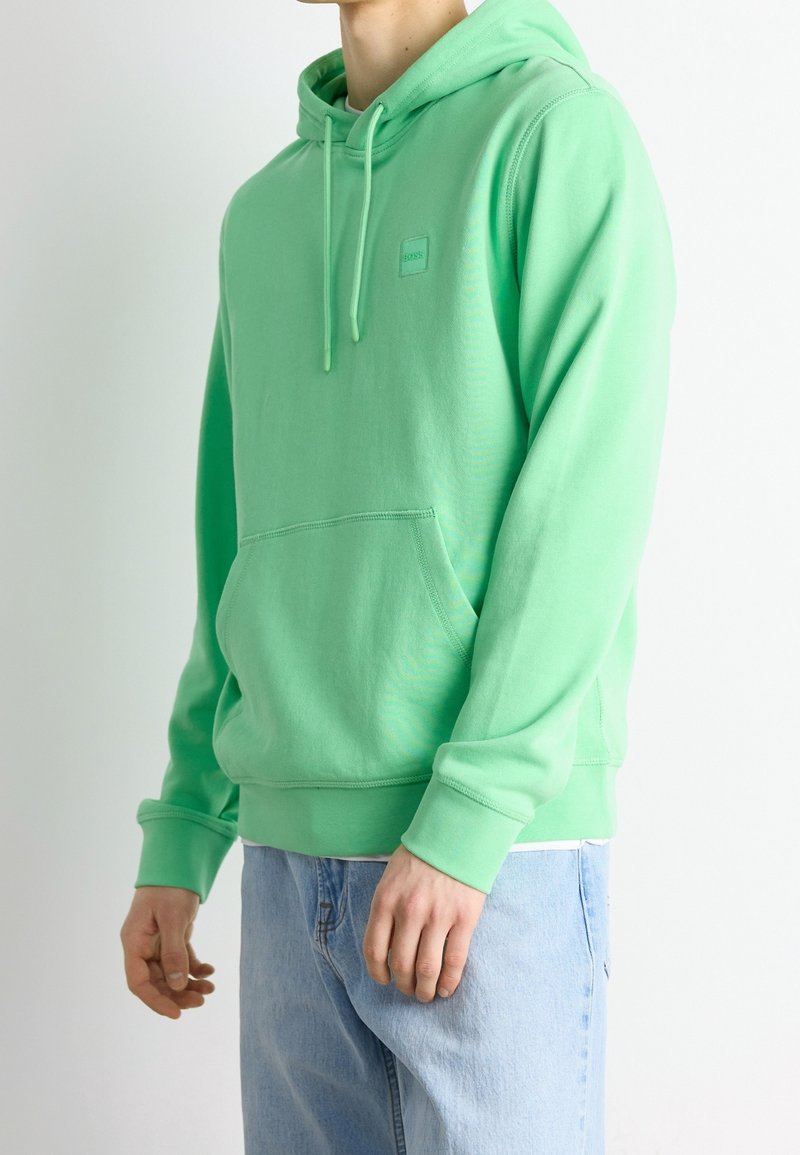 Hoodie verde menta con tasca frontale, cappuccio con cordino e una piccola etichetta logo. Tessuto morbido e liscio con polsini e orlo a costine.