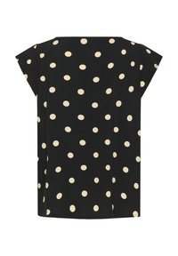 Haut noir à manches courtes avec un motif de grands pois crème. Tissu doux, coupe ample et ourlet droit.