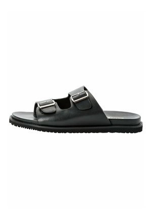 Black leather slide sandals featuring two adjustable silver buckles, a flat sole, and an open-toe design.