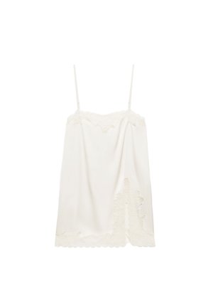 Witte satijnen camisole met dunne verstelbare bandjes en geschulpte kanten rand aan zoom en halslijn, met een kanten bloemendetail aan één kant.