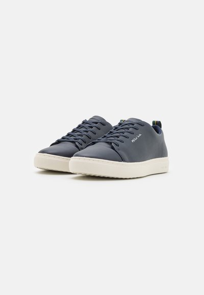 Navy leather sneakers with white rubber sole, round toe, and classic lace-up design. Rear has a multicolored striped accent.