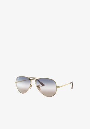 Occhiali da sole Ray-Ban aviator con montatura in metallo dorato, lenti grigie a gradiente e punte delle aste in acetato marrone. Presentano cuscinetti nasali regolabili.