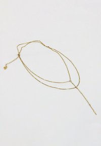 Złota naszyjnik łańcuszkowy z delikatnymi ogniwami, w kształcie litery Y, z małym serduszkiem. Lekki z polerowanym wykończeniem.