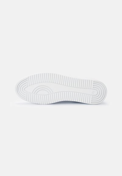 White rubber shoe sole with textured ridges, rounded toe, and smooth finish. Features a narrow groove pattern for traction.