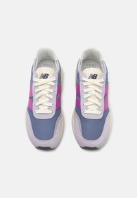 Les baskets présentent une tige en mesh violette et bleue avec des accents roses, des lacets crème et une semelle rembourrée pour plus de confort.