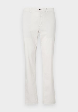Helle beigefarbene Baumwollhose mit maßgeschneidertem Schnitt, geraden Beinen, einem Reißverschluss vorne und einem Knopfverschluss.