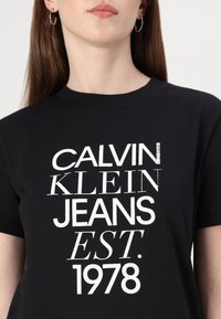 Calvin Klein Jeans MIXED LOGO REGULAR TEE - T-Shirt print - black