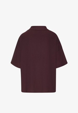 Dark burgundy short-sleeve shirt with a boxy fit and a small, flat collar, shown from the back on a white background.
