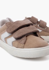 Brown suede and canvas sneakers with velcro straps, white accents, and textured rubber soles. Rounded toe design.
