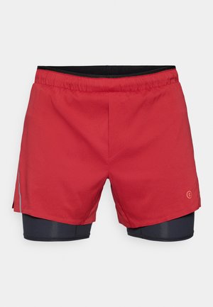 Red athletic shorts with a black elastic waistband, featuring an inner black liner and side slits for ease of movement.